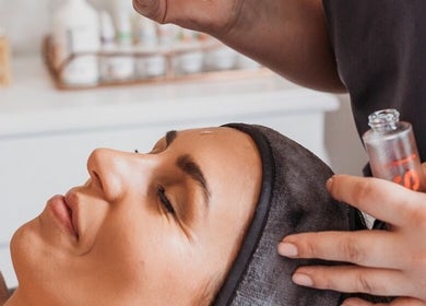 Woman enjoying a relaxing facial treatment at Rose Lounge Boutique - Book with Ashley, Somerset West, Western Cape, ZA.