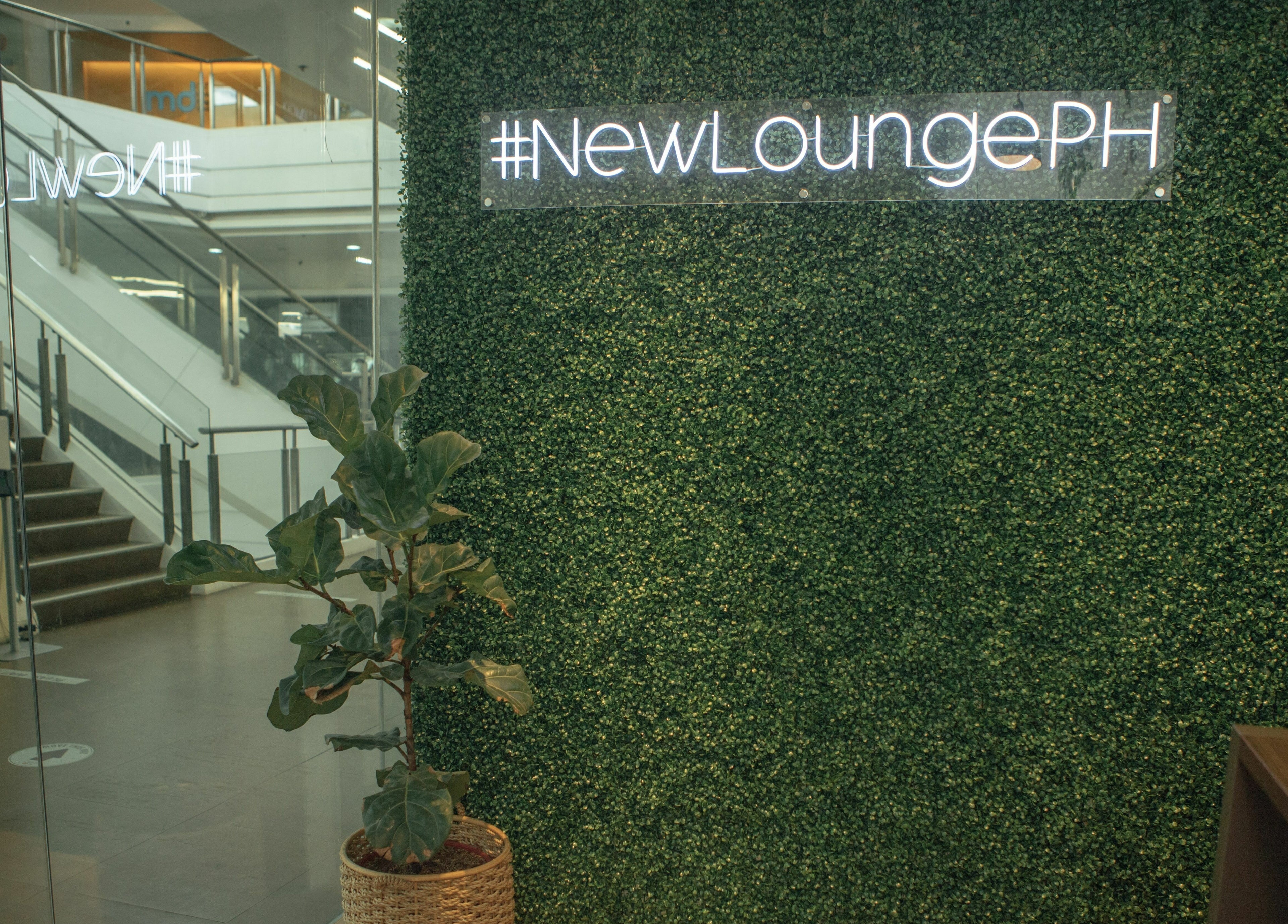 Entrance of NEW Lounge Westgate Alabang with greenery wall sign in Muntinlupa, Metro Manila, PH.