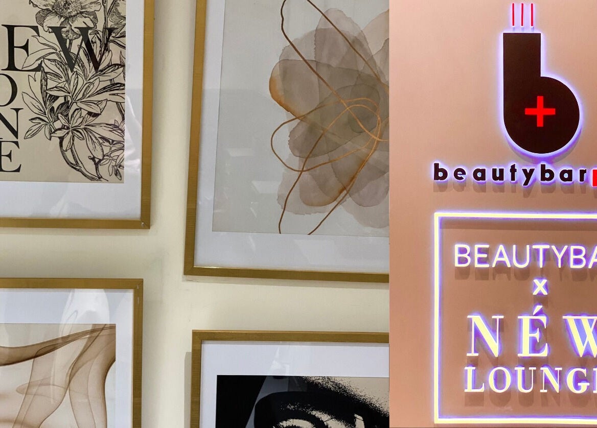 Artistic wall decor and logo at NEW Lounge Glorietta, Makati, Metro Manila, PH. Stylish and inviting atmosphere.