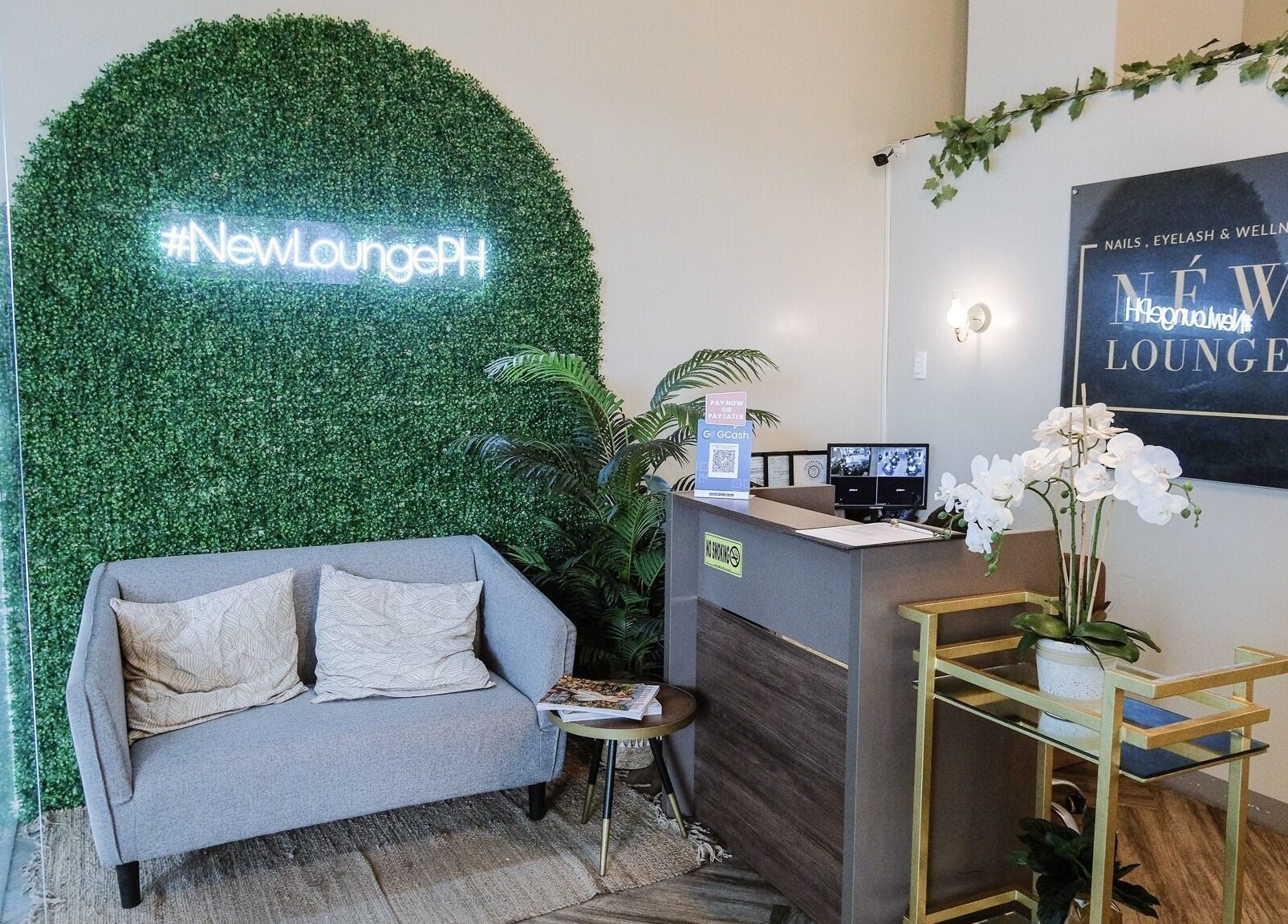 Entrance of NEW Lounge Cebu, a stylish beauty oasis in Cebu, PH, with cozy seating and modern design.