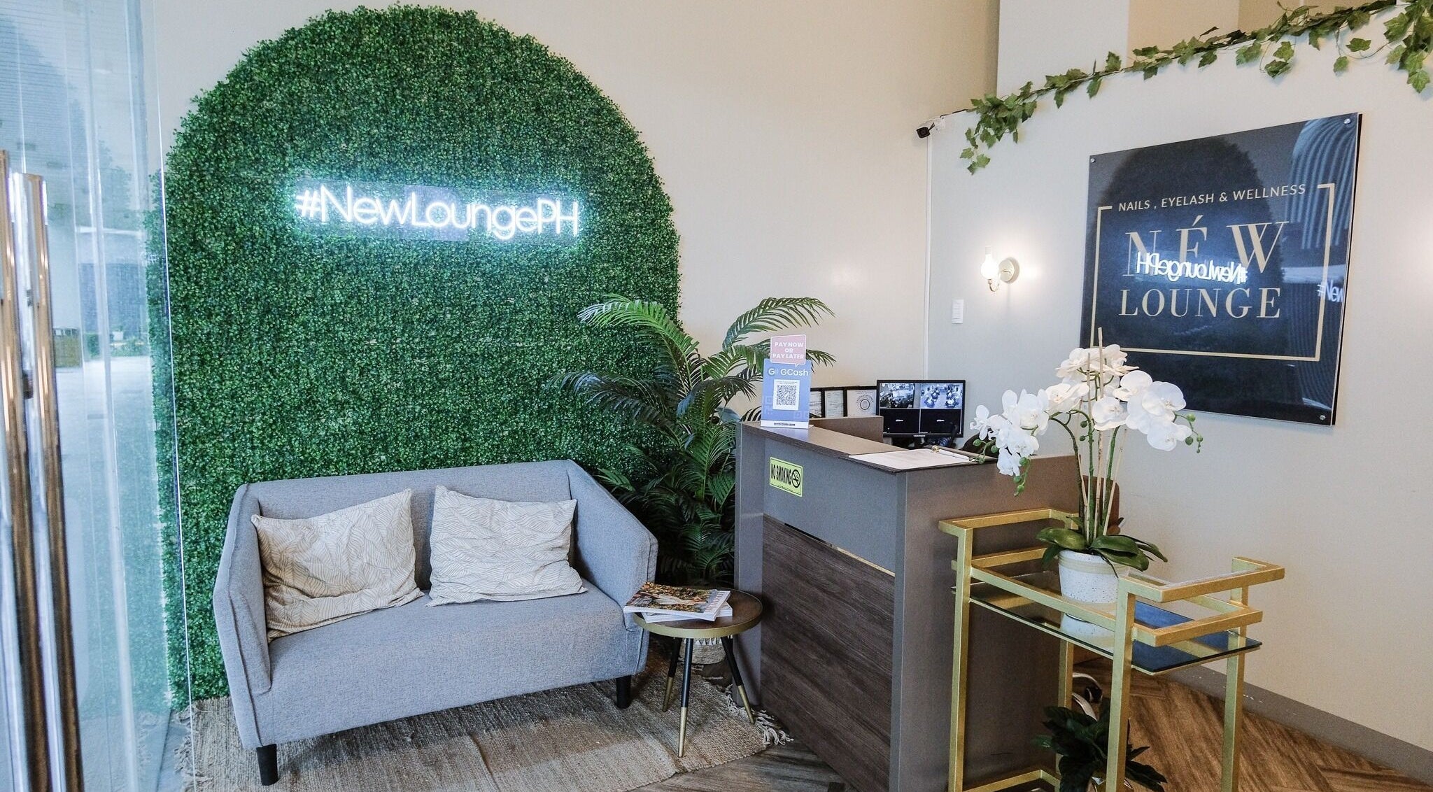Entrance of NEW Lounge Cebu, a stylish beauty oasis in Cebu, PH, with cozy seating and modern design.
