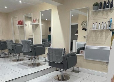 Interior of Chantelle Douglas Hairdressing, Falkirk, Scotland. Modern styling chairs and mirrors.