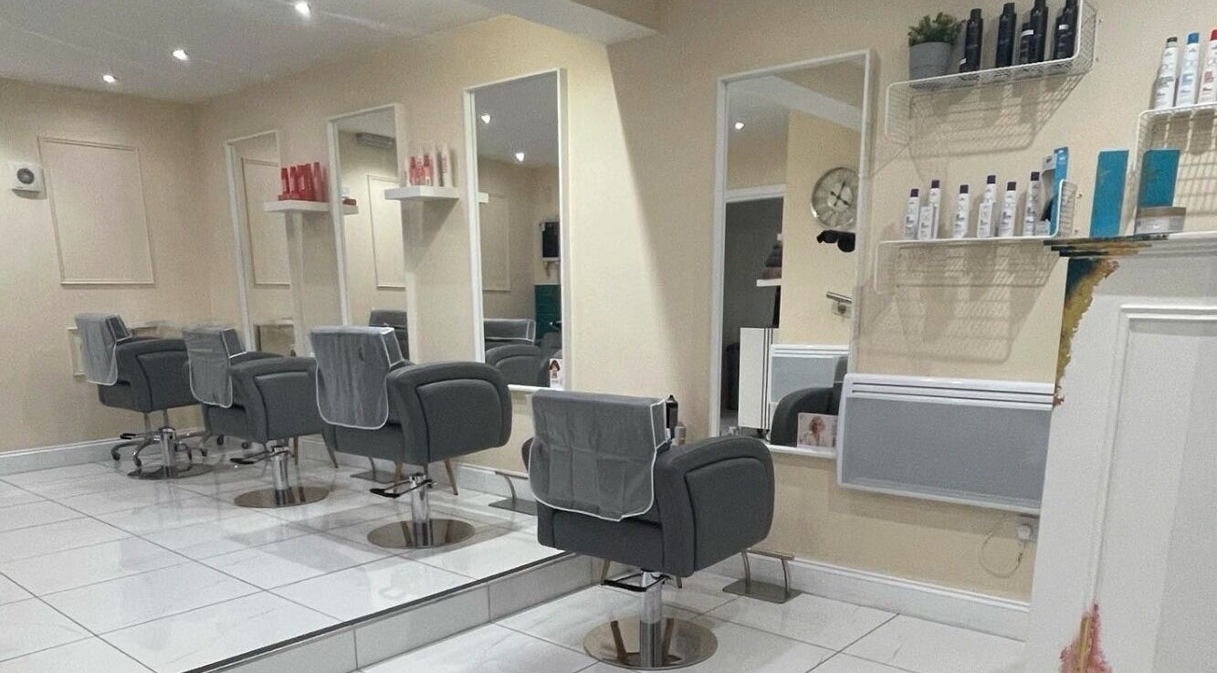 Interior of Chantelle Douglas Hairdressing, Falkirk, Scotland. Modern styling chairs and mirrors.
