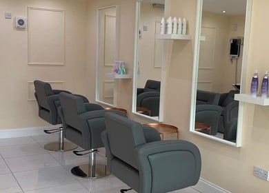 Chic interior of Chantelle Douglas Hairdressing, Falkirk, Scotland, GB featuring sleek styling chairs and mirrors.