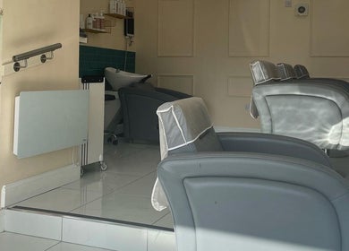 Modern salon chairs in Chantelle Douglas Hairdressing, Falkirk, Scotland, GB, reflect a serene atmosphere.