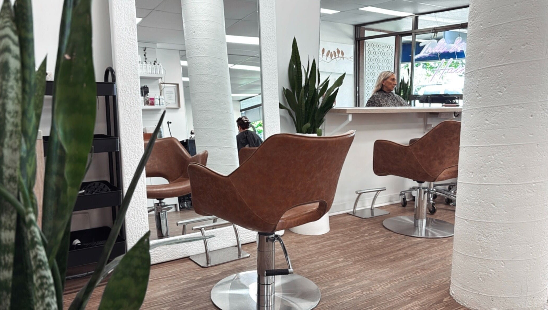 Modern salon interior at Hair by Cesca, Mooloolaba, Queensland, AU with stylish chairs and mirrors.