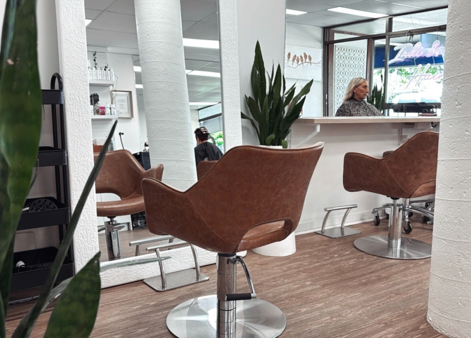 Modern salon interior at Hair by Cesca, Mooloolaba, Queensland, AU with stylish chairs and mirrors.