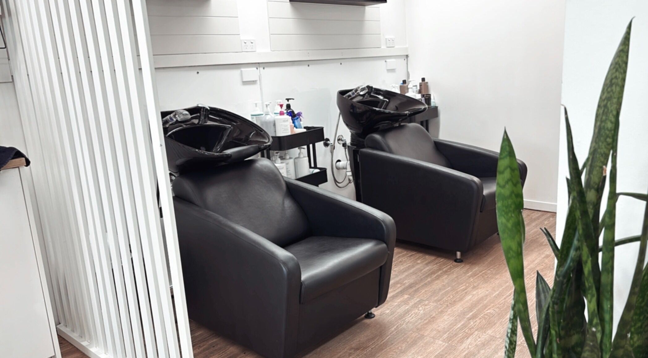 Modern shampoo chairs at Hair by Cesca, Mooloolaba, Queensland, AU, highlighting sleek salon design.
