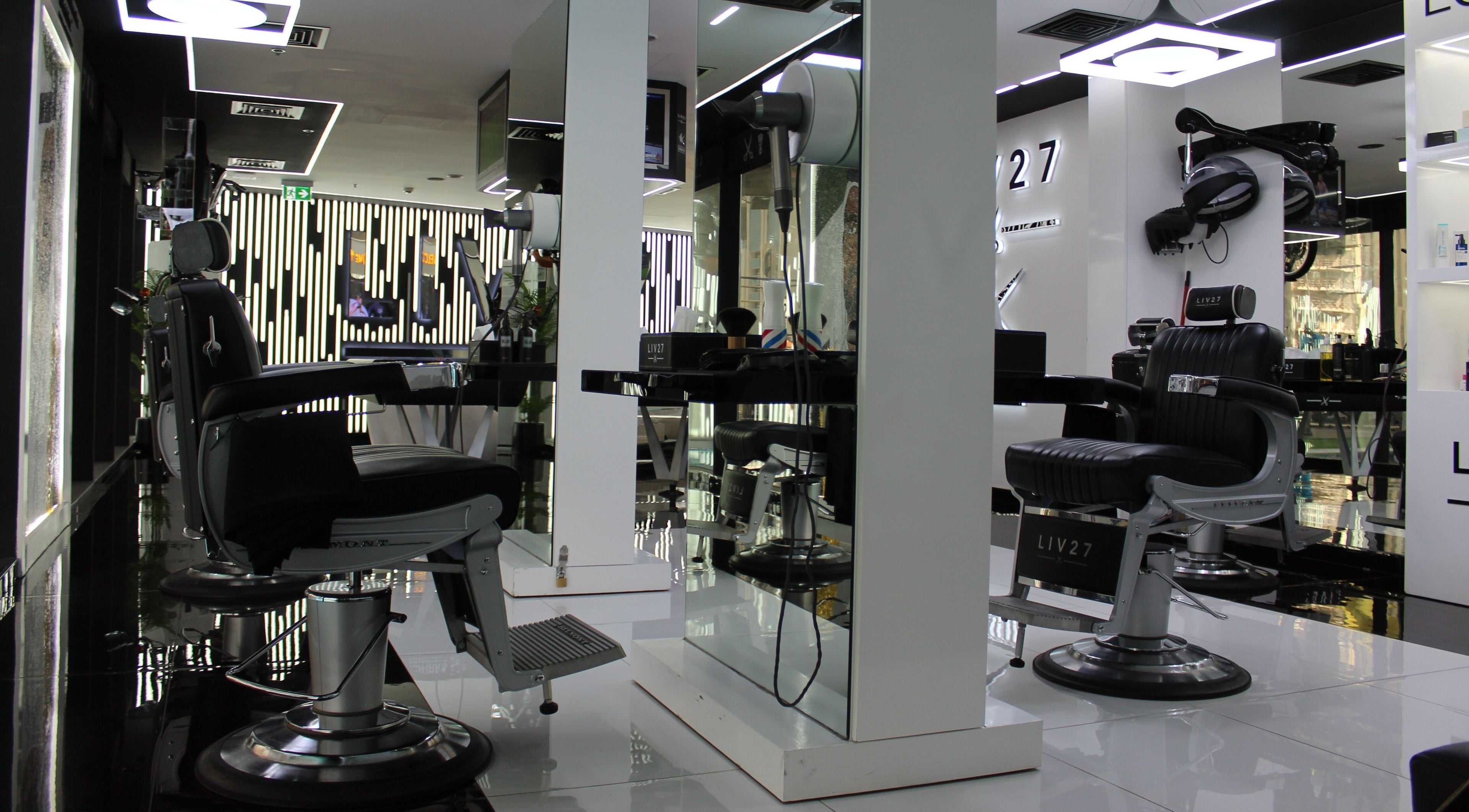 Sleek black barber chairs at LIV27 - Media City Branch, Dubai, Dubai, AE for premium grooming services.