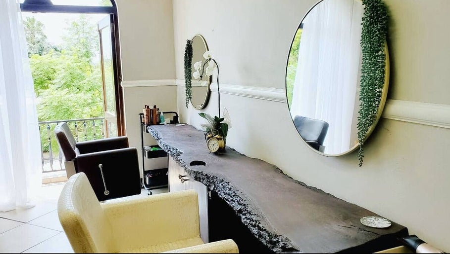 Ahead of Hair salon in Sandton, Gauteng, ZA. Bright room with mirrors, chairs, and modern decor.