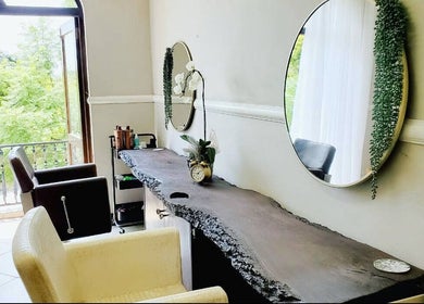Ahead of Hair salon in Sandton, Gauteng, ZA. Bright room with mirrors, chairs, and modern decor.