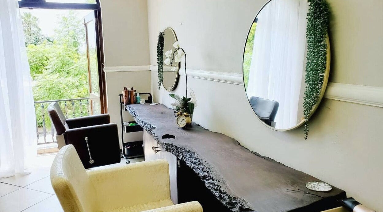 Ahead of Hair salon in Sandton, Gauteng, ZA. Bright room with mirrors, chairs, and modern decor.