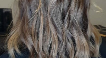 Elegant wavy hairstyle at Ahead of Hair, Sandton, Gauteng, ZA, showcasing vibrant color and shine.