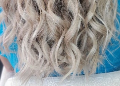 Blonde wavy hairstyle at Ahead of Hair, Sandton, Gauteng, ZA, showcasing vibrant salon expertise.