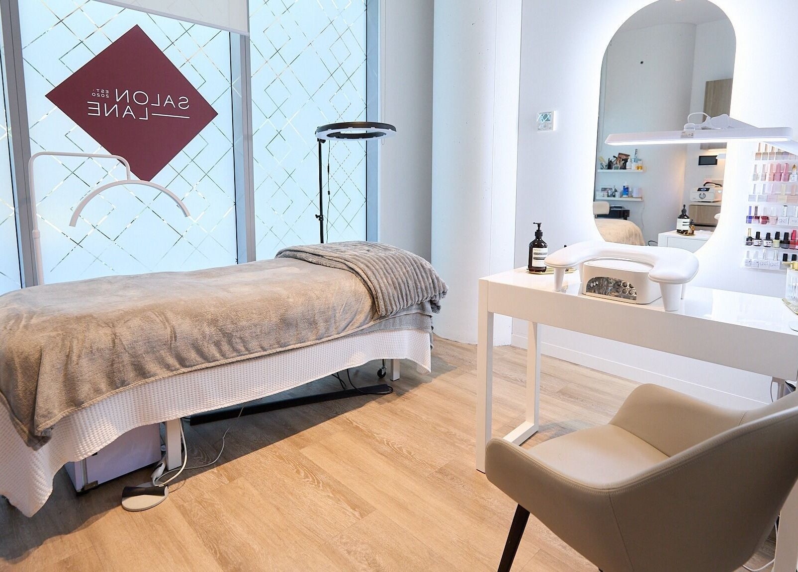Serene treatment room at Beauty by Kitty, St Leonards, New South Wales, AU, showcasing spa bed and nail station.