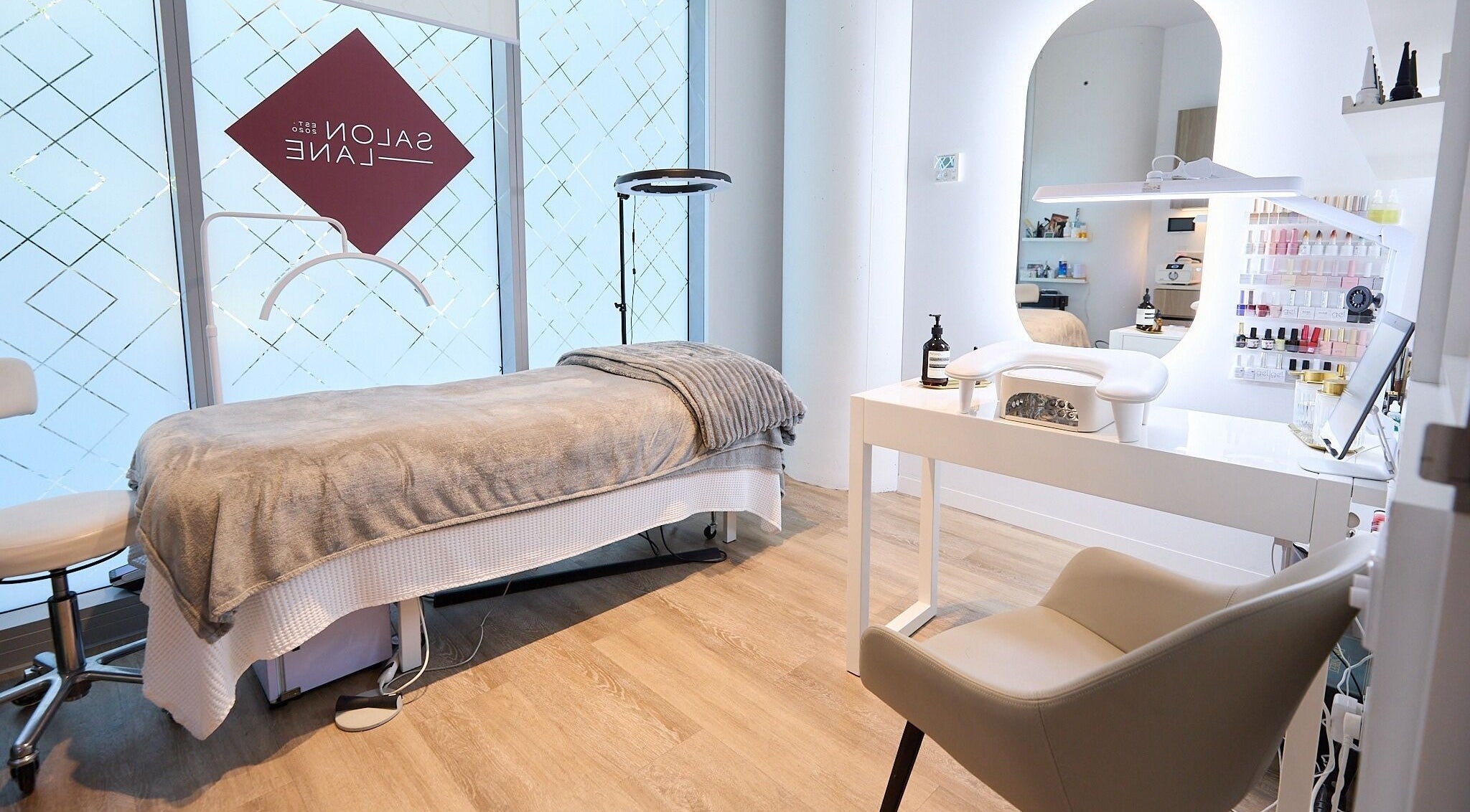 Serene treatment room at Beauty by Kitty, St Leonards, New South Wales, AU, showcasing spa bed and nail station.
