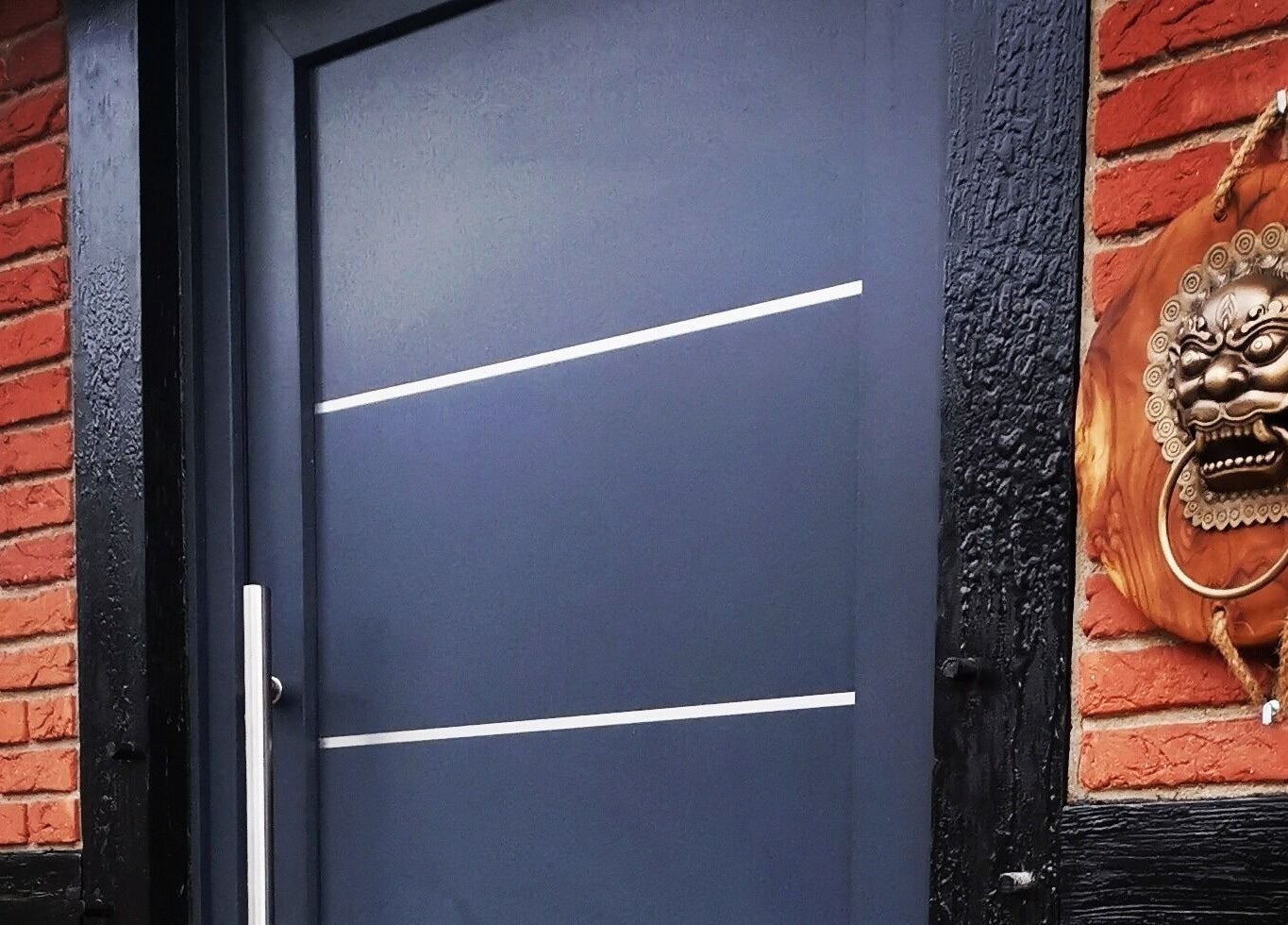 Eingang der Body Mind Academy in Kiel, Schleswig-Holstein, DE mit dekorativem Löwen-Türklopfer.