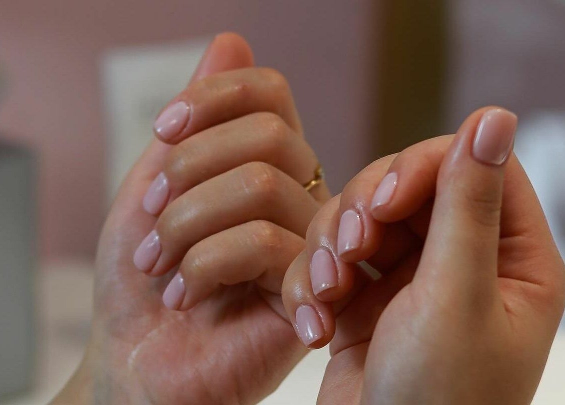 Elegant pink manicure at Dore Ladies Salon, Dubai, AE, showcasing polished nails.