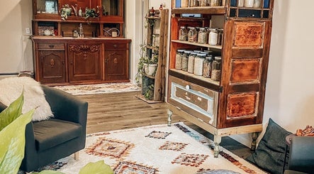 Inviting rustic interior of Mama Flowers in Kutztown, Pennsylvania, US, showcasing elegant wooden cabinets and plush seating.