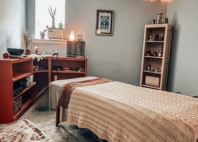 Cozy wellness room at Mama Flowers, Kutztown, Pennsylvania, US with massage table and ambient lighting.