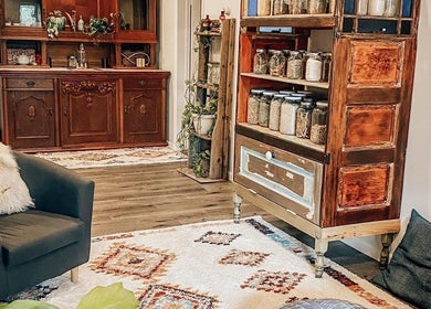 Warm interior at Mama Flowers, Kutztown, Pennsylvania, US. Vintage furniture with jars and plants create a cozy vibe.