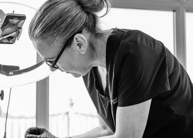 Professional beautician at Finishing Touches Skin & Beauty, York, England, GB, performing precise beauty treatment.