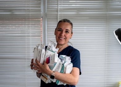 Smiling staff at Finishing Touches Skin & Beauty in York holding beauty products.