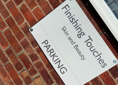 Parking sign for Finishing Touches Skin & Beauty, York, England, GB, on a brick wall.