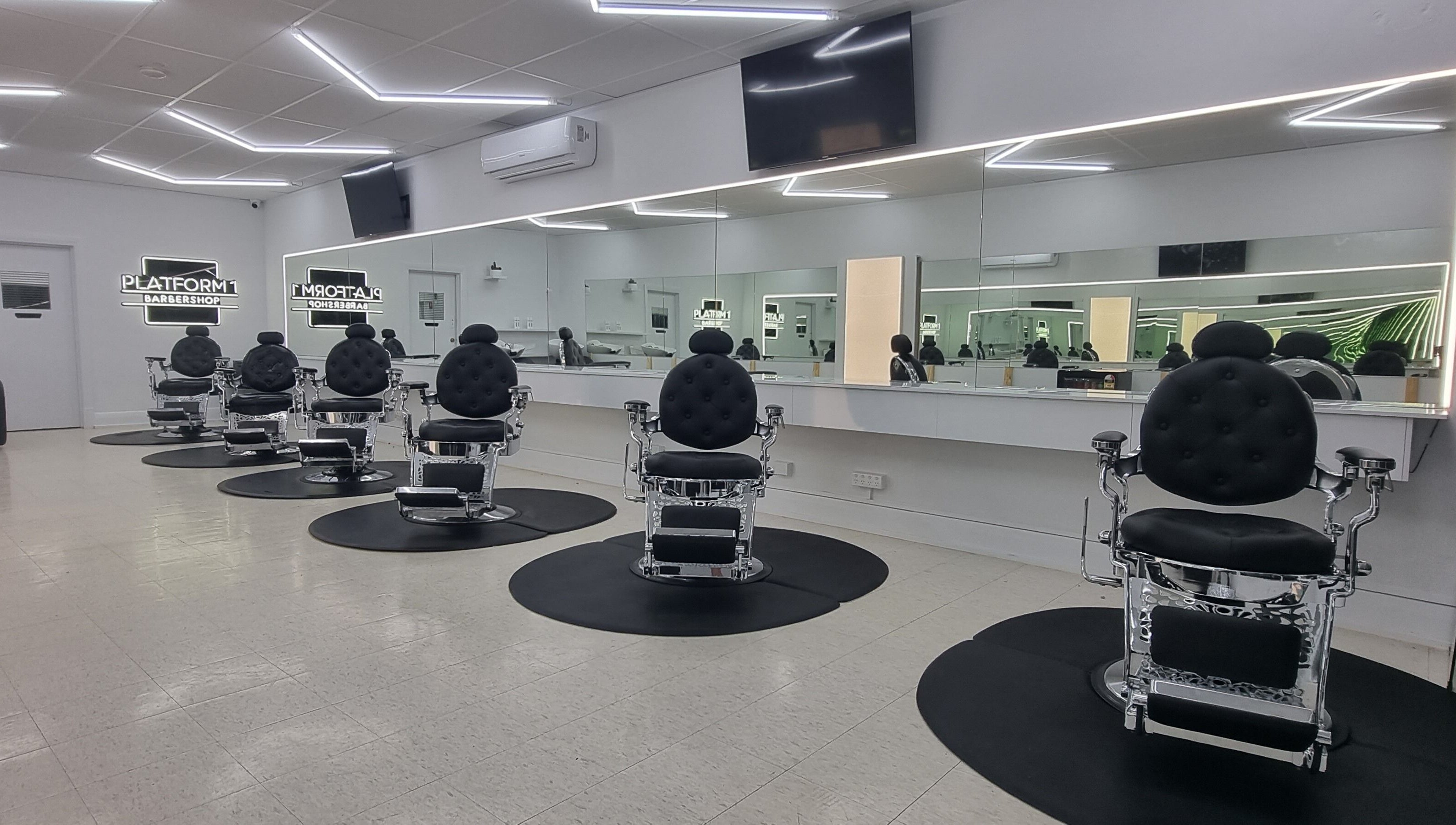 Luxurious chairs at Platform 1 Barbershop in Seaton, South Australia, AU with sleek, modern design.