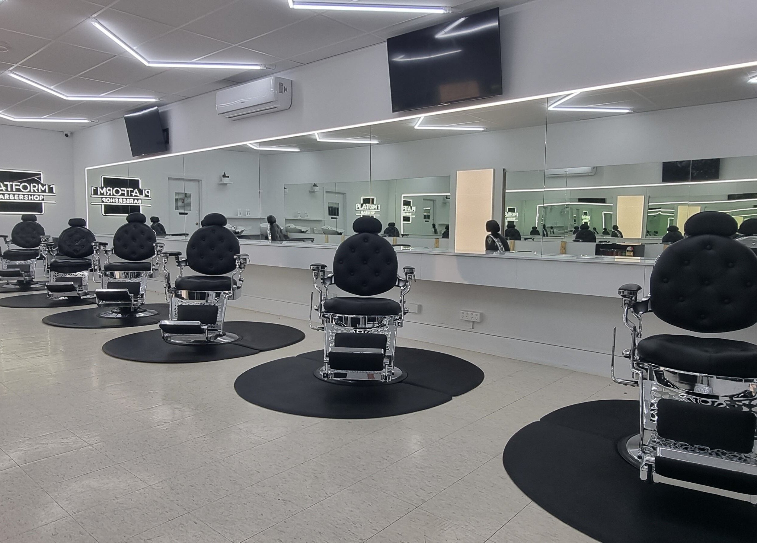 Luxurious chairs at Platform 1 Barbershop in Seaton, South Australia, AU with sleek, modern design.