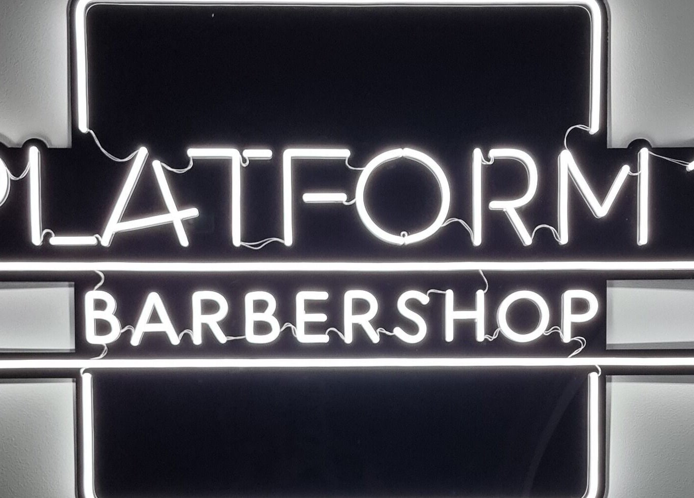 Platform 1 Barbershop neon sign in Seaton, South Australia, AU, highlighting modern style.