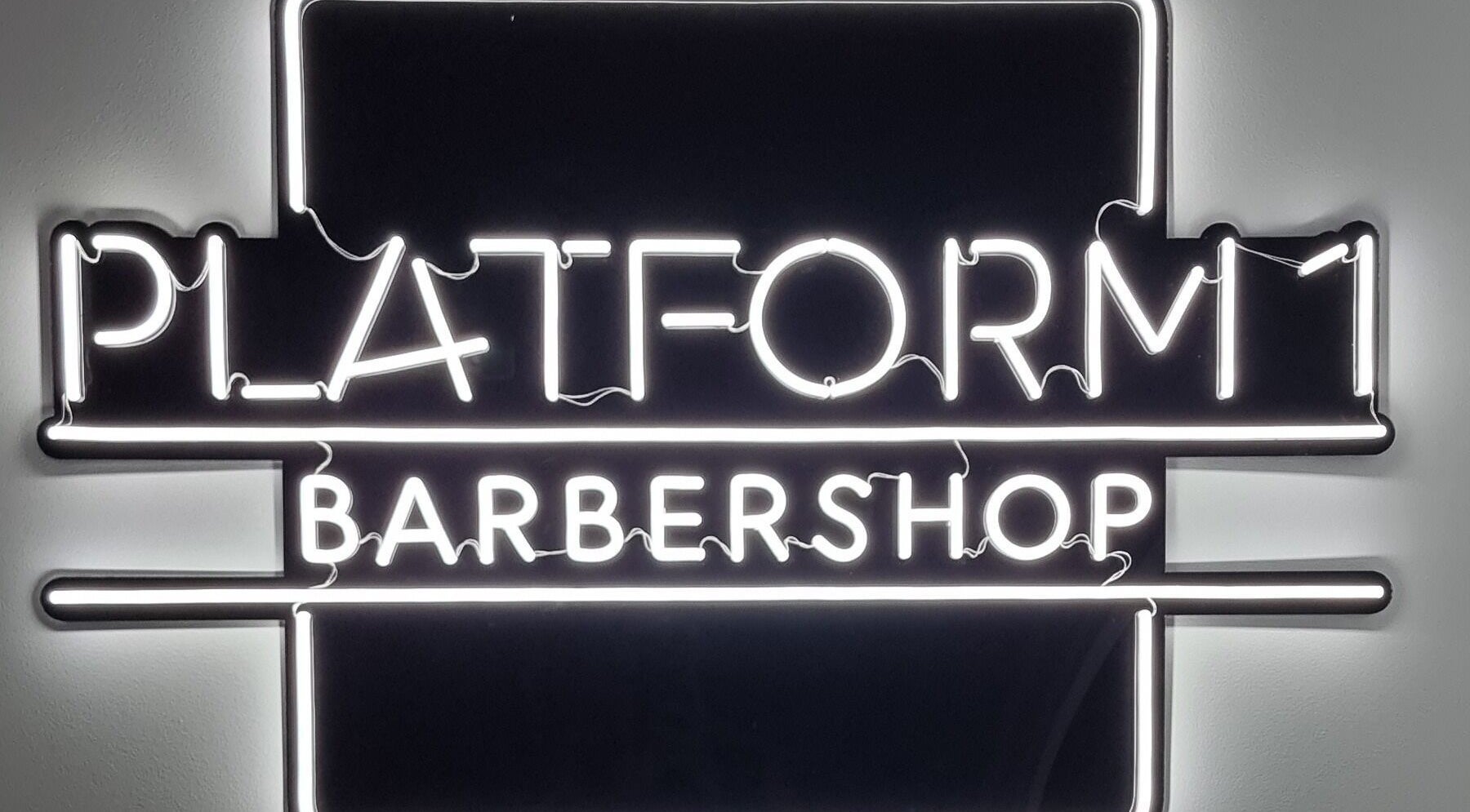 Platform 1 Barbershop neon sign in Seaton, South Australia, AU, highlighting modern style.