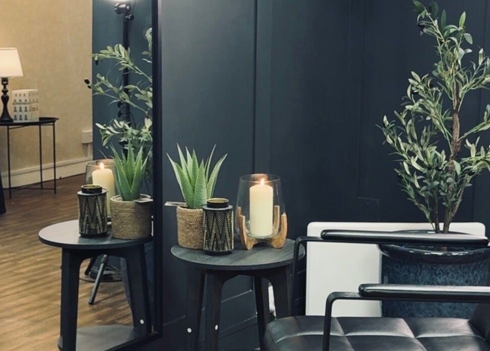 Cozy corner with plants and candles at Scott McKinnon Aesthetics and Skin Clinic, Saltcoats, Scotland, GB.