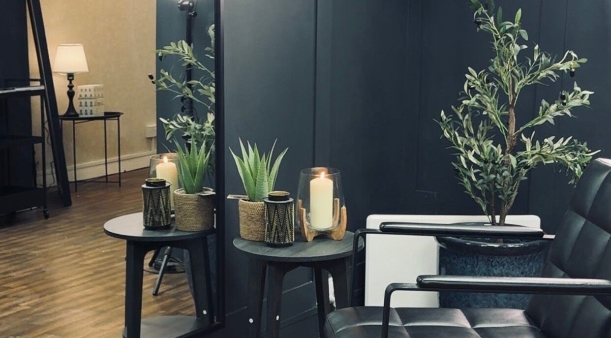 Cozy corner with plants and candles at Scott McKinnon Aesthetics and Skin Clinic, Saltcoats, Scotland, GB.