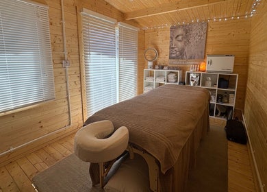 Calming therapy room at Rio Bluebell Therapies in Salisbury, England, GB with soft lighting and cozy massage bed.