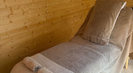 Relaxing therapy bed setup at Rio Bluebell Therapies, Salisbury, England, GB, with soft bedding and warm lighting.