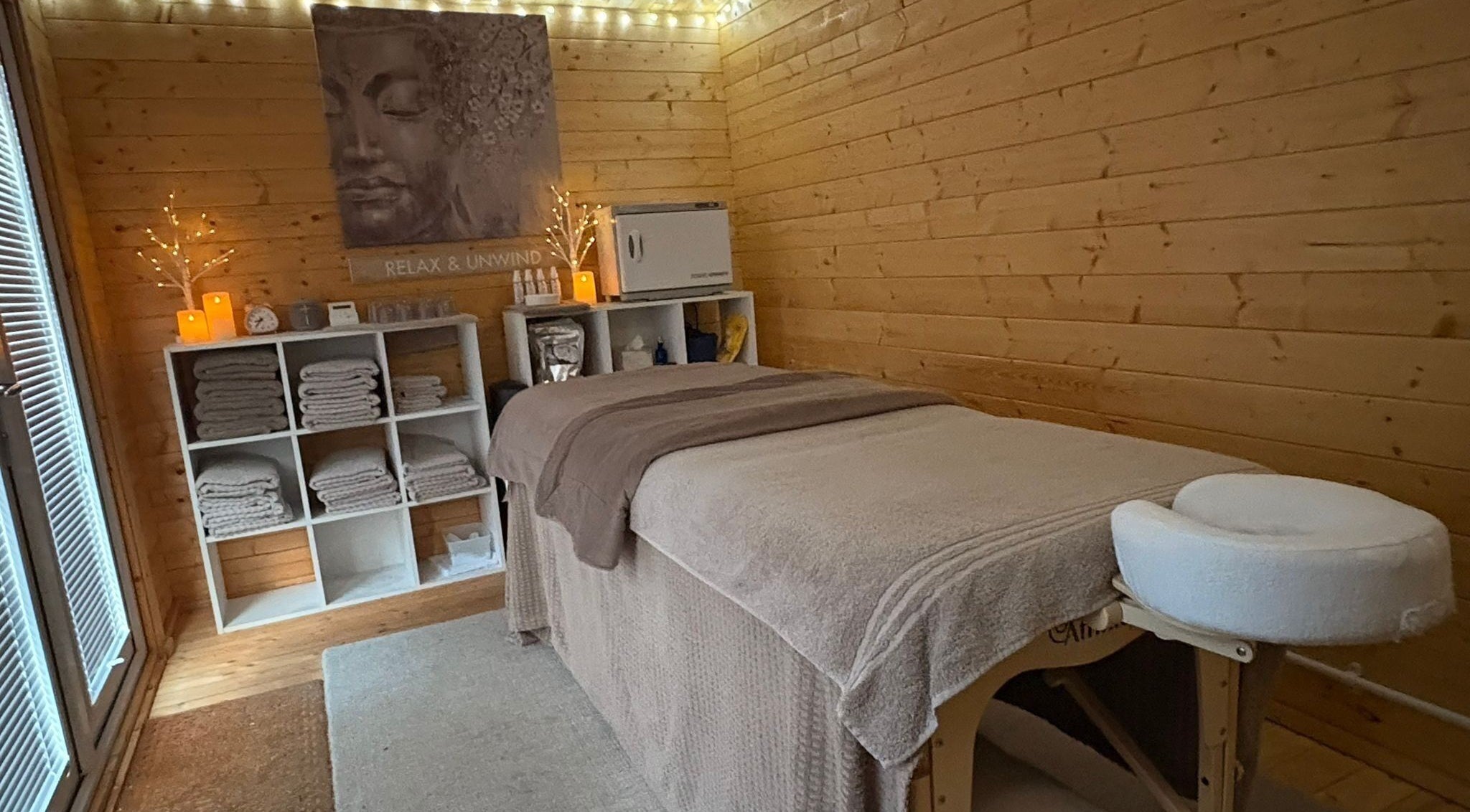 Cozy massage room at Rio Bluebell Therapies, Salisbury, England, GB with massage bed and ambient lighting.