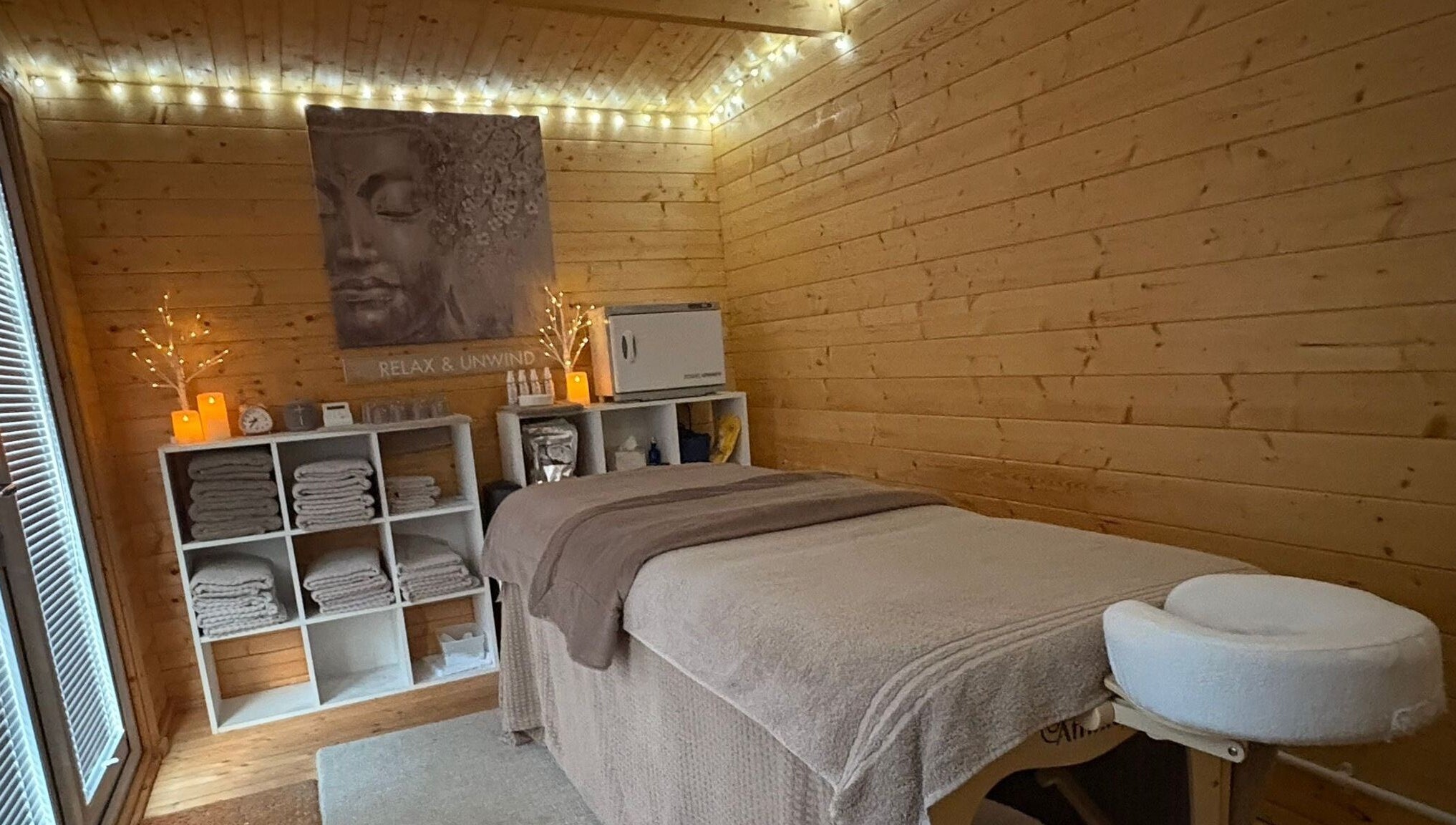 Relaxing therapy room at Rio Bluebell Therapies, Salisbury, England, GB, with cozy lights and massage table.