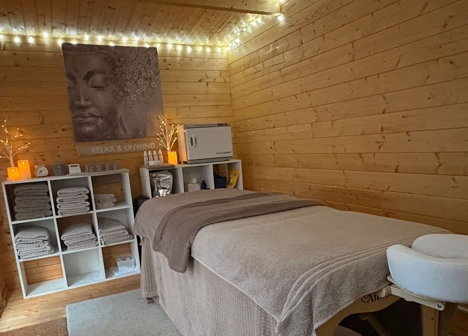 Relaxing therapy room at Rio Bluebell Therapies, Salisbury, England, GB, with cozy lights and massage table.