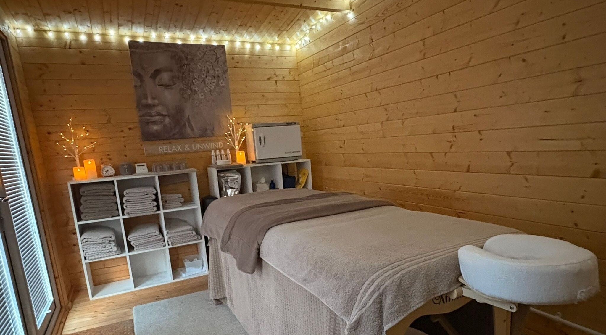 Relaxing therapy room at Rio Bluebell Therapies, Salisbury, England, GB, with cozy lights and massage table.