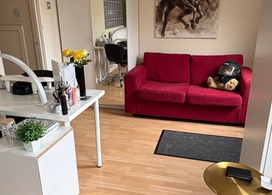Elegant salon interior at Nails by Sonya Stark, Leeds, England, GB with red sofa and stylish decor.