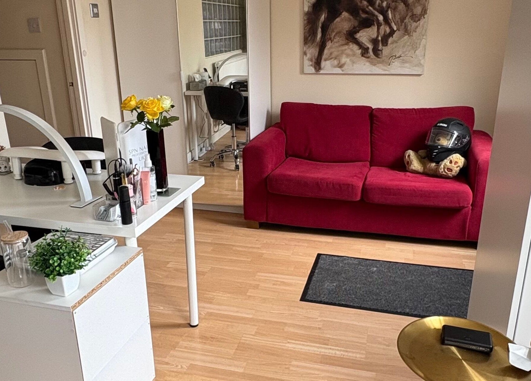 Cozy reception with red couch at Nails By Sonya Stark in Leeds, England, GB showcasing modern decor.