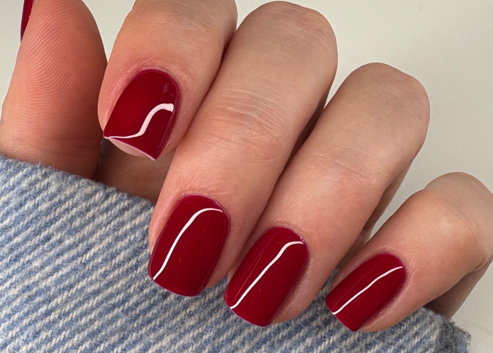 Red polished nails at Nails By Sonya Stark, Leeds, England, GB showcasing elegant manicure style.