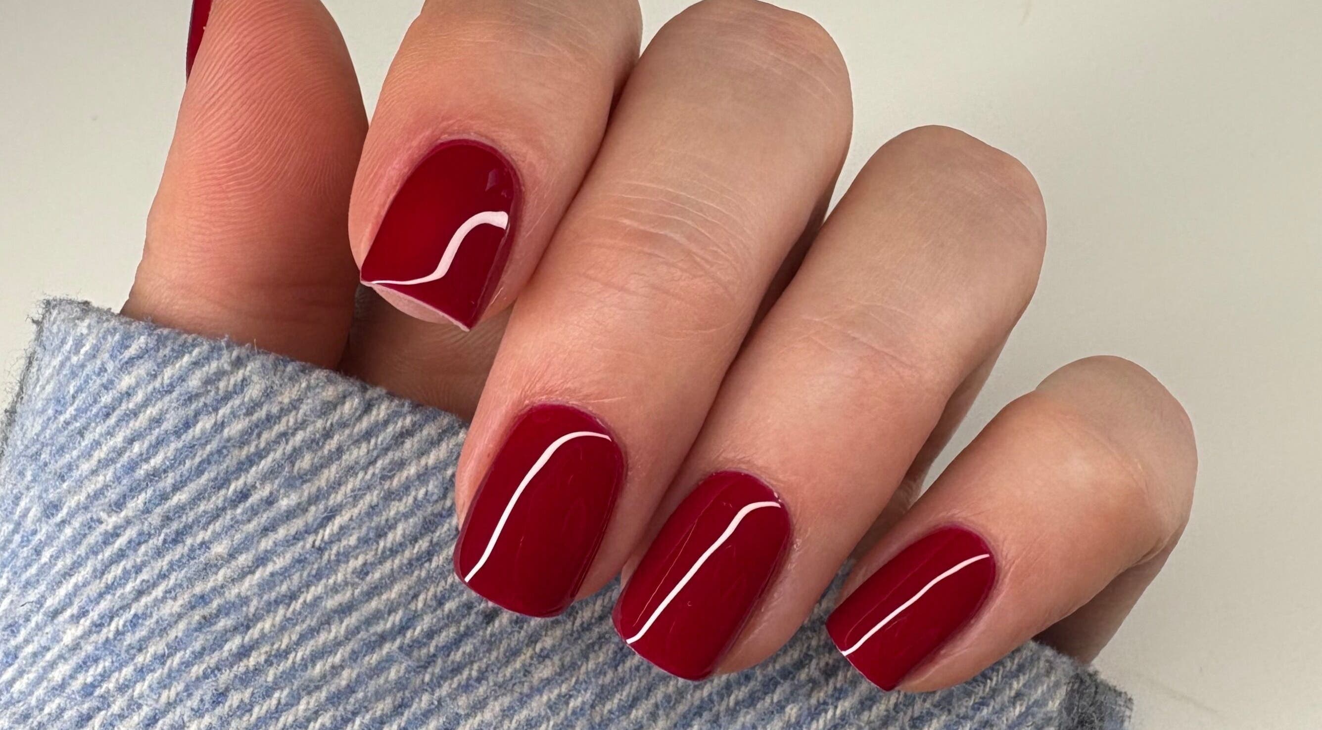 Red polished nails at Nails By Sonya Stark, Leeds, England, GB showcasing elegant manicure style.