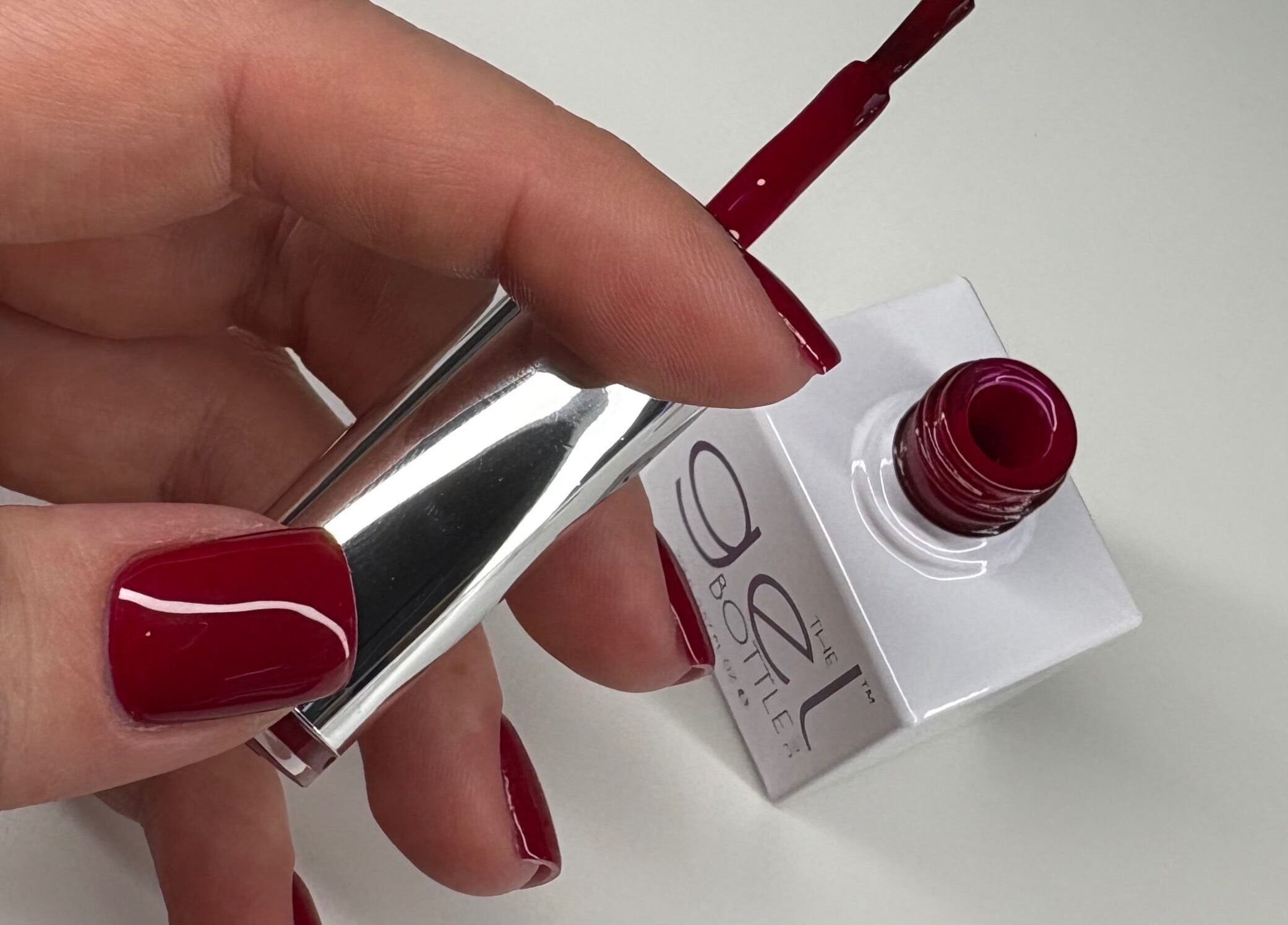 Close-up of a red polished nail being painted at Nails By Sonya Stark, Leeds, England, GB.