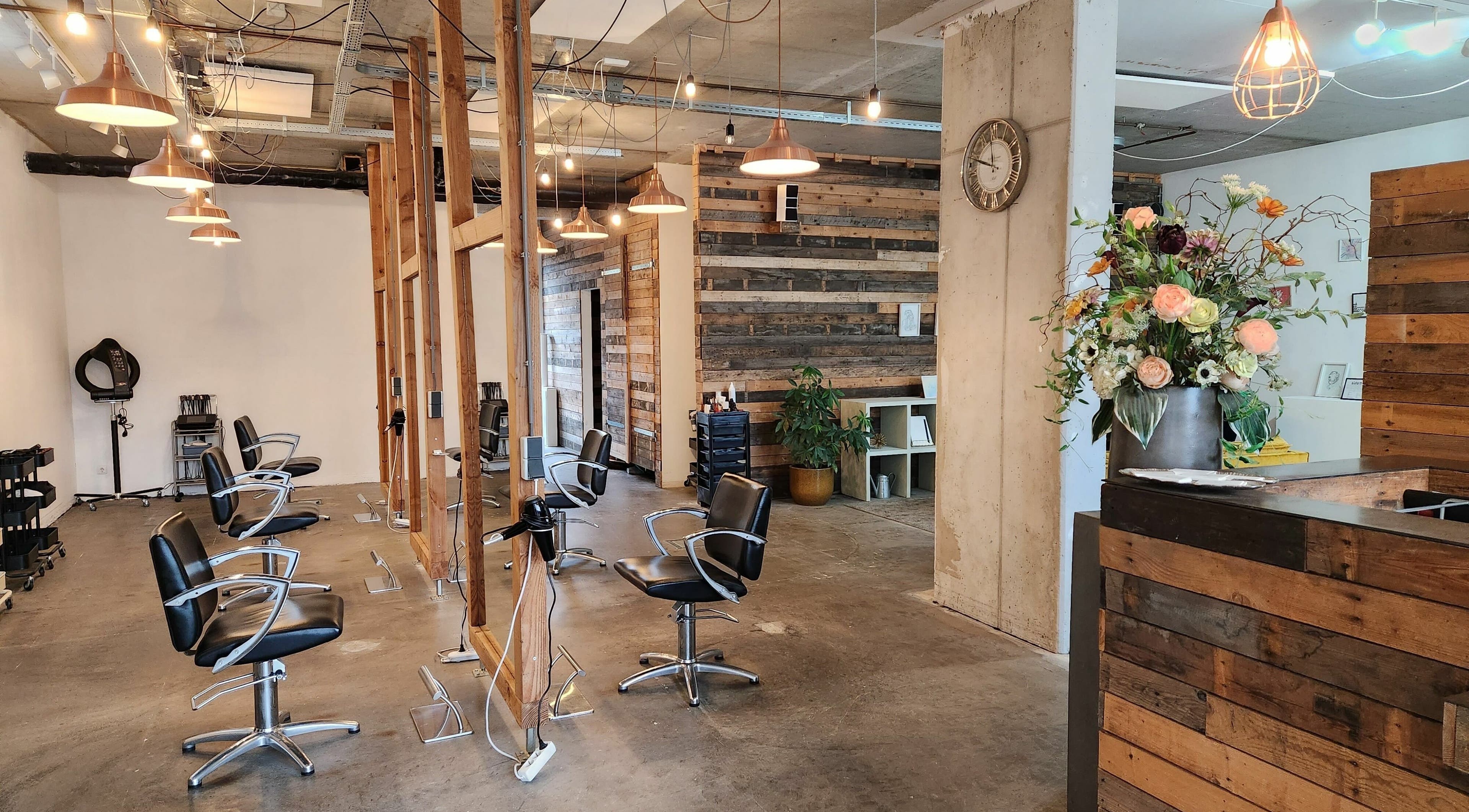 Stylish interior of Hair Salon SEPTEMBER in Amsterdam, Noord-Holland, NL, featuring modern chairs and decor.