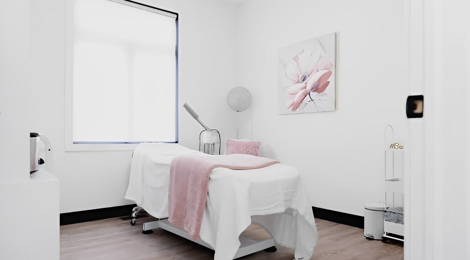 Calm massage room at Komosis Studio by Niki Christopher in Belleville, Ontario, CA with soft lighting and decor.