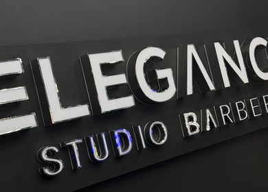 Signage of Elegance Studio Barbers in Paphos, CY, showcasing modern design.