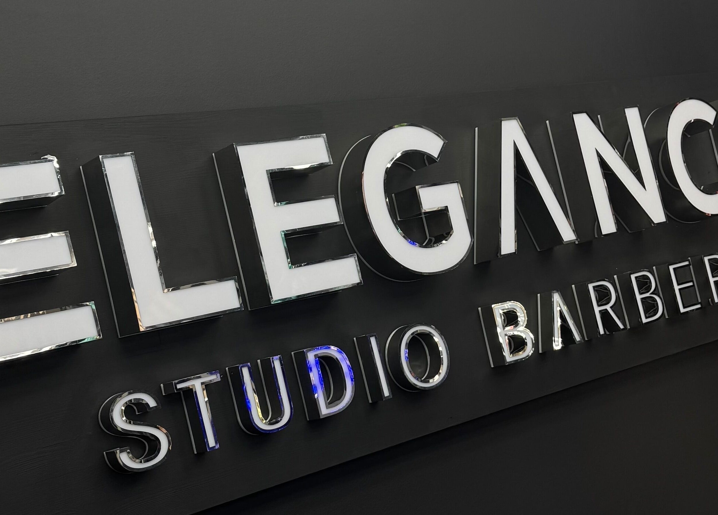 Signage of Elegance Studio Barbers in Paphos, CY, showcasing modern design.