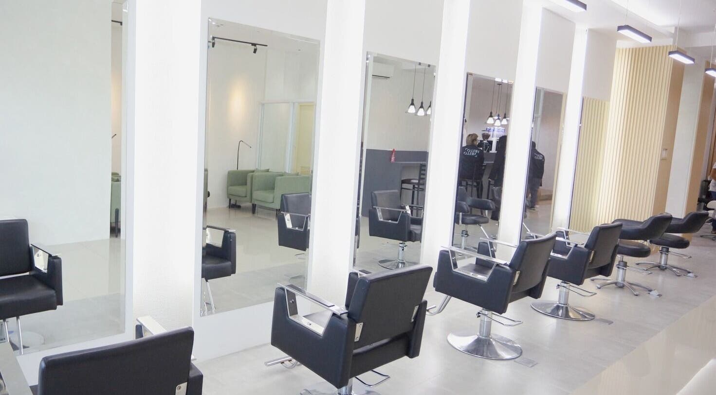 Modern salon interior at HelloMello Salon in Angeles, Central Luzon, PH with sleek styling chairs and mirrors.